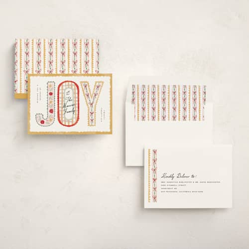 This is a butter non photo holiday cards with standard by Pixel and Hank called joy ribbon printing on signature in standard