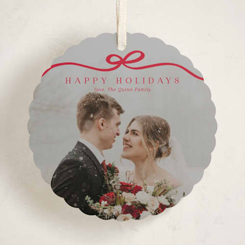 This is a cardinal holiday card ornaments with standard by Kaydi Bishop called bow tied printing on recycled smooth signature in ornament
