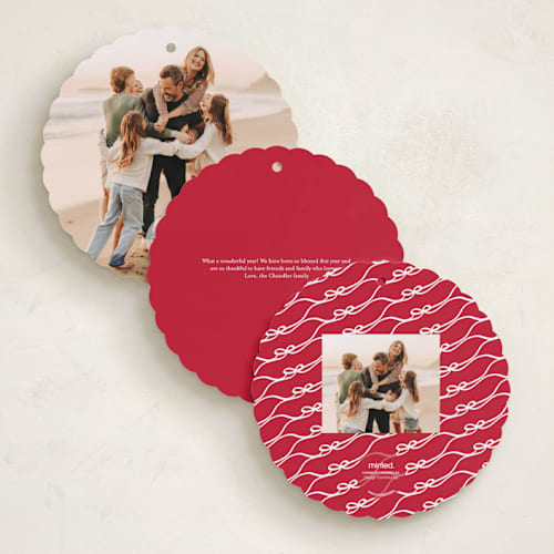 This is a cardinal holiday card ornaments with standard by Kaydi Bishop called bow tied printing on recycled smooth signature in ornament
