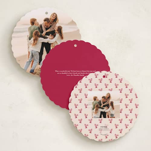 This is a cranberry holiday card ornaments with standard by Teju Reval called scalloped holly printing on recycled smooth signature in ornament