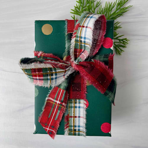 This is a multicolorassorted-colors holiday decorations by Honey Silks Co called 1” hand frayed cotton holiday plaid - 5 yards in standard