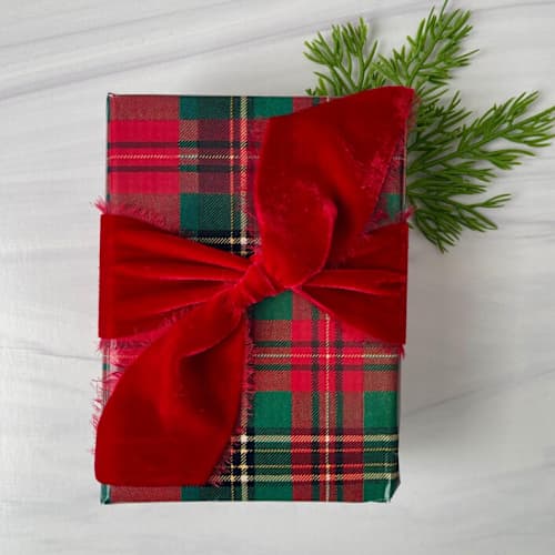 This is a red holiday decorations by Honey Silks Co called 2" silk velvet ribbon - red in standard