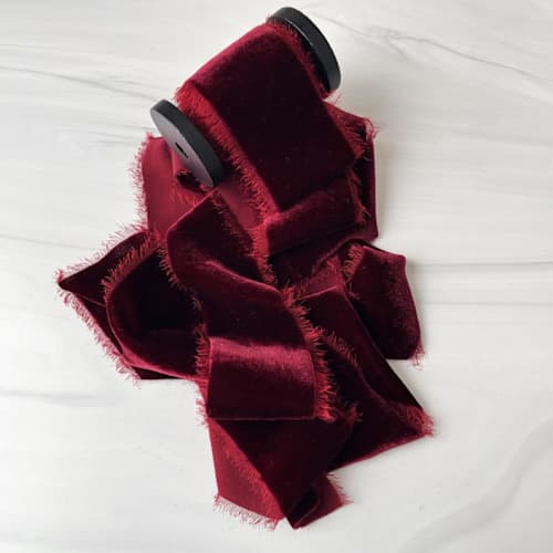 This is a red holiday decorations by Honey Silks Co called 2" silk velvet ribbon - scarlet in standard