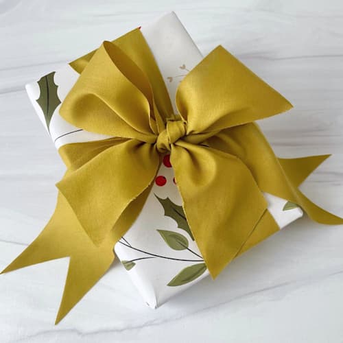 This is a green holiday decorations by Honey Silks Co called deep golden pear holiday ribbon - 2" x 15 feet in standard