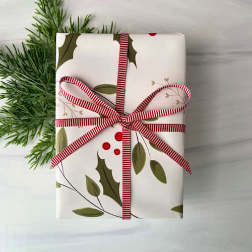 This is a red holiday decorations by Honey Silks Co called 1/4" x 15 feet vertical stripe holiday ribbon in standard