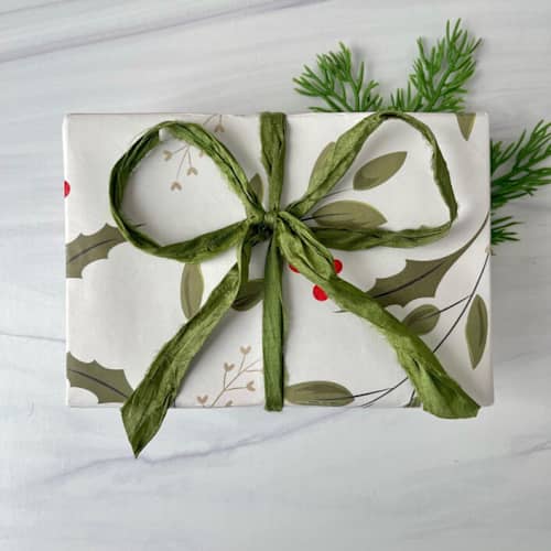 This is a green holiday decorations by Honey Silks Co called holly green sari silk ribbon - 10 yards in standard