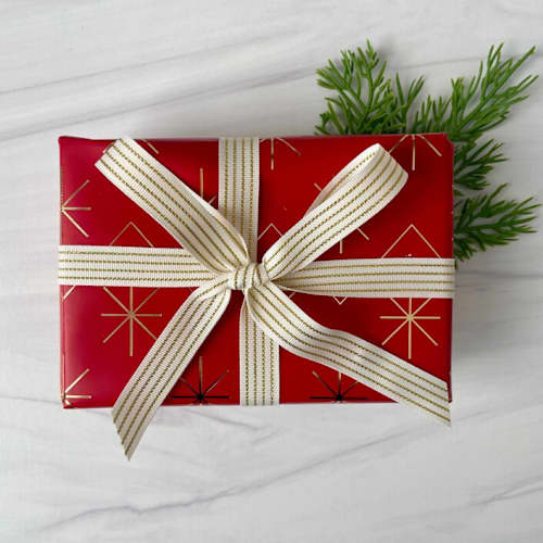 This is a white holiday decorations by Honey Silks Co called 5/8” ivory and gold striped holiday ribbon in standard