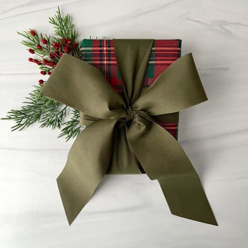This is a green holiday decorations by Honey Silks Co called olive 2" x 15 ft holiday ribbon in standard