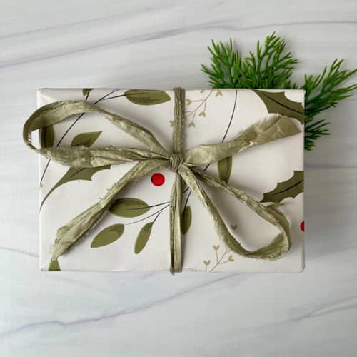 This is a green holiday decorations by Honey Silks Co called sage sari silk ribbon - 10 yards in standard