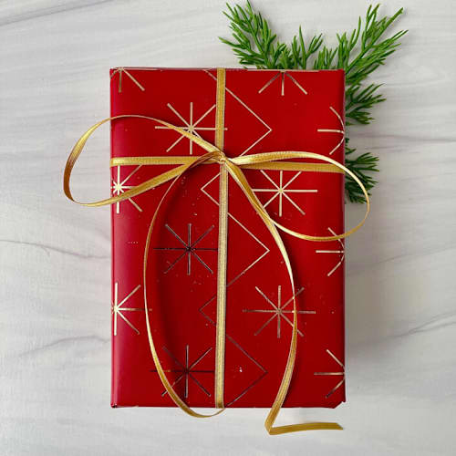 This is a gold holiday decorations by Honey Silks Co called gold holiday ribbon 1/8" x 10 yards in standard