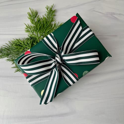 This is a green holiday decorations by Honey Silks Co called forest green stripe 7/8" x 15 ft holiday ribbon in standard