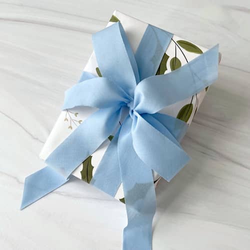 This is a blue holiday decorations by Honey Silks Co called sky blue holiday ribbon 1" x 15 feet in standard