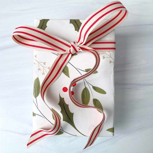 This is a red holiday decorations by Honey Silks Co called cream and red ticking holiday ribbon - 5/8" x 15 feet in standard