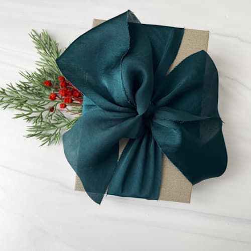 This is a green holiday decorations by Honey Silks Co called 2" holiday ribbon collection - winter spruce in standard
