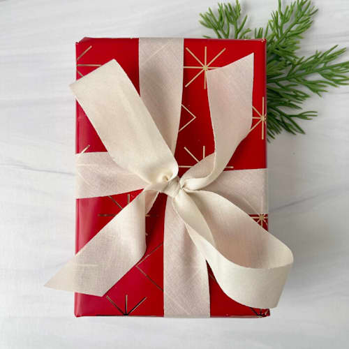 This is a white holiday decorations by Honey Silks Co called 1” cream cotton holiday ribbon - 15 feet in standard