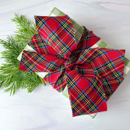 This is a red holiday decorations by Honey Silks Co called tartan plaid cotton holiday ribbon in standard
