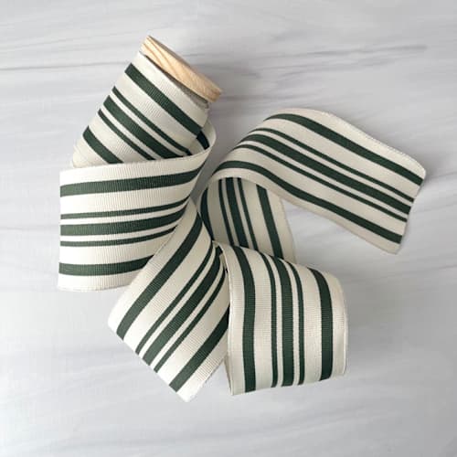 This is a green holiday decorations by Honey Silks Co called 2.5" green cotton ribbon - 5 yards in standard