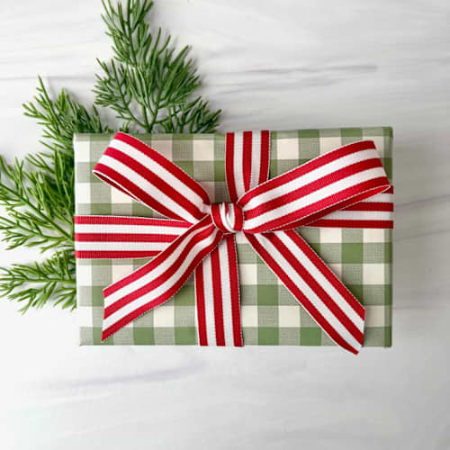 This is a red holiday decorations by Honey Silks Co called red stripe 7/8" x 15 ft holiday ribbon in standard