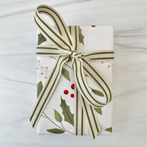 This is a green holiday decorations by Honey Silks Co called cream and green ticking holiday ribbon 5/8" x 15 feet in standard