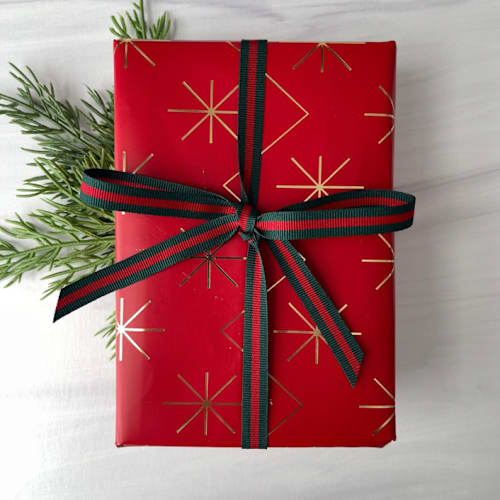 This is a red holiday decorations by Honey Silks Co called 3/8" x 15 feet hampton holiday ribbon in standard