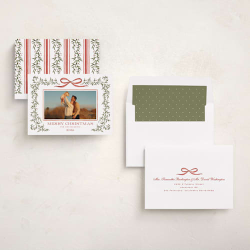This is a holly berry holiday photo cards with standard by Wildfield Paper Co called laurel wreath printing on recycled smooth signature in standard
