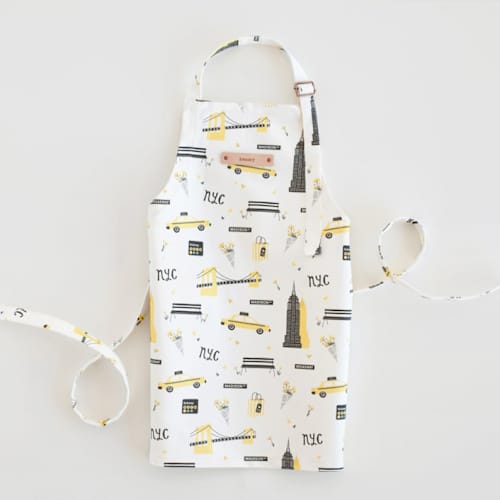 This is a taxi yellow kids aprons by Kristie Kern called new york in standard