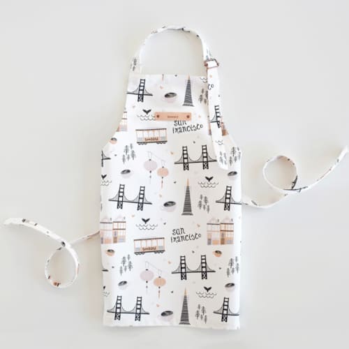 This is a violet kids aprons by Kristie Kern called san francisco in standard