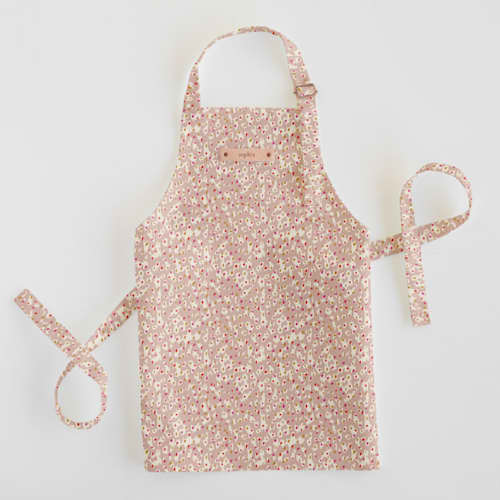 This is a tan kids aprons by Michelle Fifis called animal dots in standard