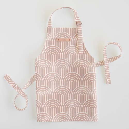 This is a pink kids aprons by Hooray Creative called deco arches in standard