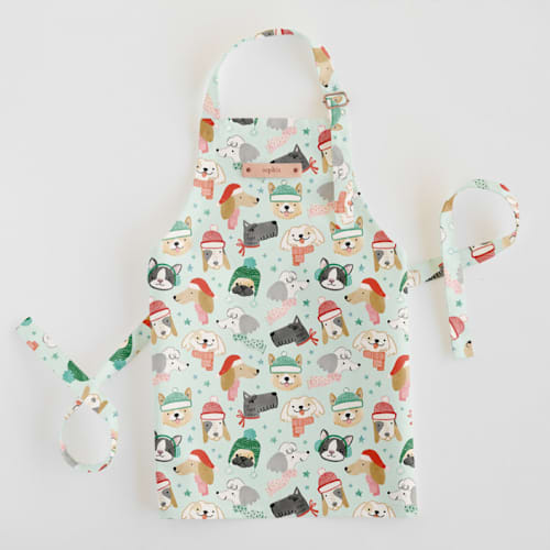 This is a mint kids aprons by Monika Torun called christmas puppies in standard