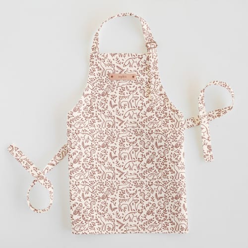 This is a cinnamon kids aprons by Teju Reval called enchanted holiday in standard