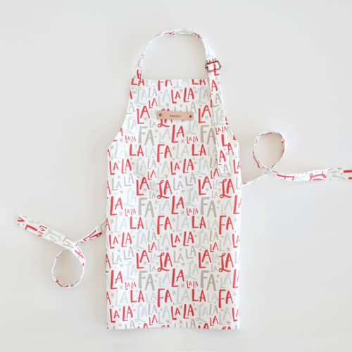 This is a red berry kids aprons by Hooray Creative called festive falala in standard
