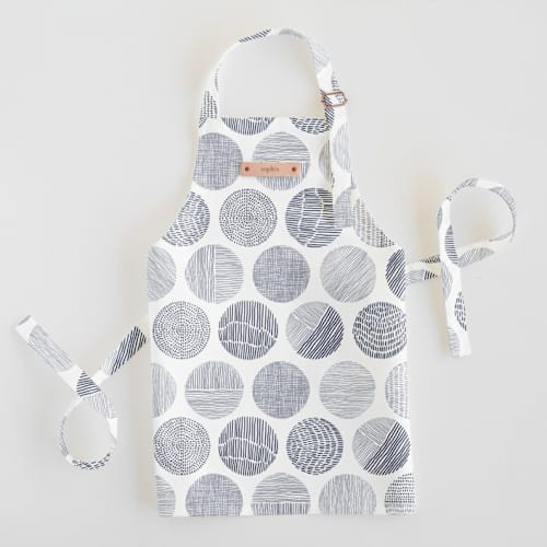 This is a navy kids aprons by Sabrin Deirani called minimalist circles in standard