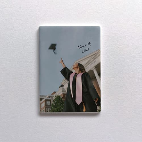 This is a white all gifts by Holly Whitcomb called custom ceramic photo magnet - grad in standard