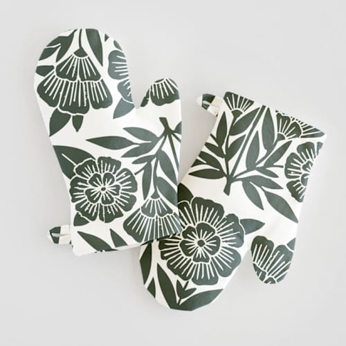 This is a dark teal kids aprons by Katharine Watson called block print floral in standard