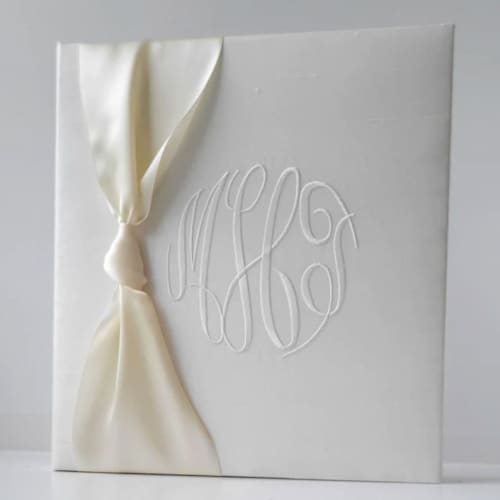 This is a white wedding gifts by Annie May called wedding memory book — ivory silk w/satin ribbon in standard