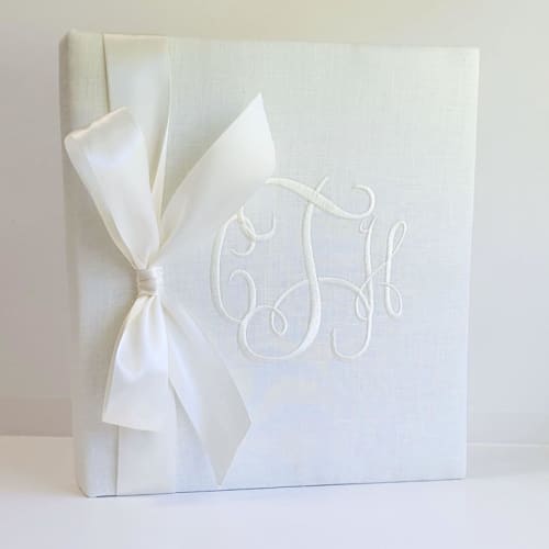 This is a white wedding gifts by Annie May called wedding memory book — ivory linen w/satin ribbon in standard