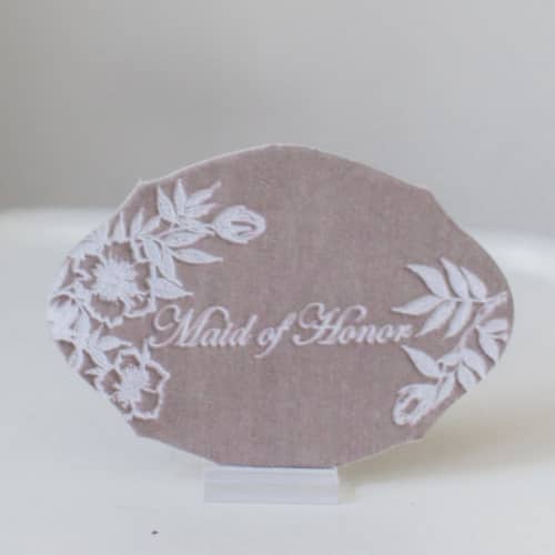 This is a beige bridesmaid gifts by Velvet Raptor called maid of honor oval card in standard