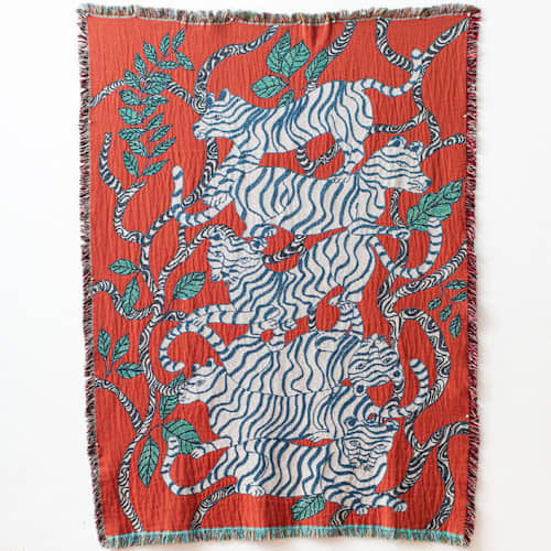 This is a red throw blankets by Olivia Wendel called red tigers blanket in standard