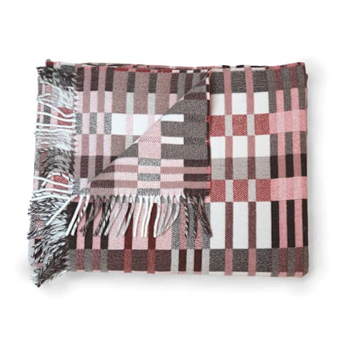 This is a pink throw blankets by freya walker called lambswool throw | calamine + rust in standard