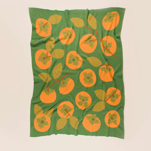 This is a green throw blankets by Superstitchous called persimmon throw blanket in standard