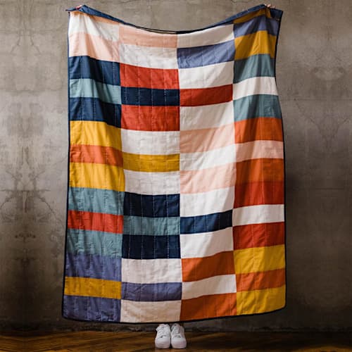 This is a multicolor throw blankets by Anchal called multi-check quilt throw in standard
