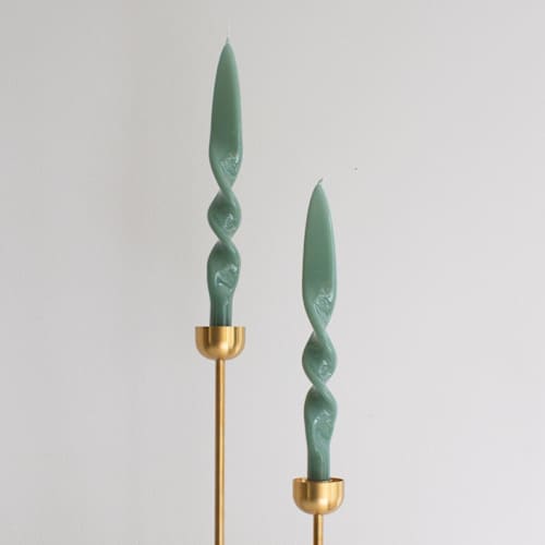 This is a green candles and candle holders by the parmatile shop called taper candle set (sage) in standard