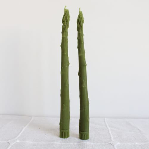 This is a green candles and candle holders by Happy Organics called asparagus taper beeswax candles pair in standard