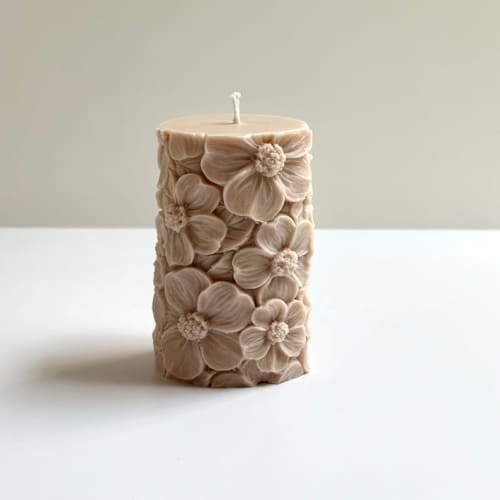 This is a beige candles and candle holders by Over By The Moon called beige floral pillar in standard