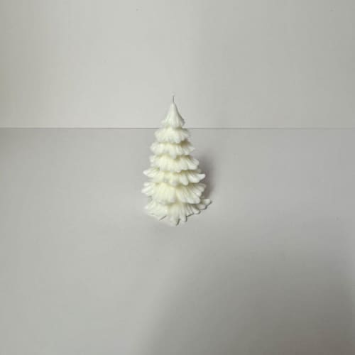 This is a white candles and candle holders by Over By The Moon called small white christmas tree candle in standard