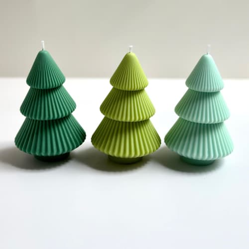 This is a green candles and candle holders by Over By The Moon called green christmas trees set of 3 in standard