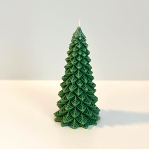 This is a green candles and candle holders by Over By The Moon called medium green christmas tree candle in standard