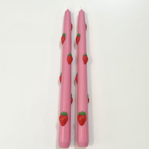 This is a multicolor candles and candle holders by Over By The Moon called pink strawberry tapers in standard