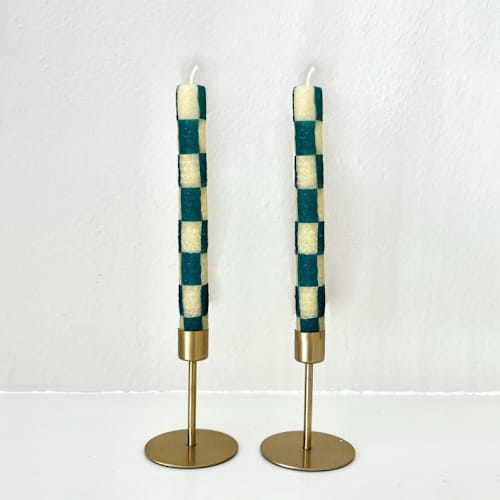 This is a green candles and candle holders by Annie Shapiro called checkered taper candles (green & beige) in standard